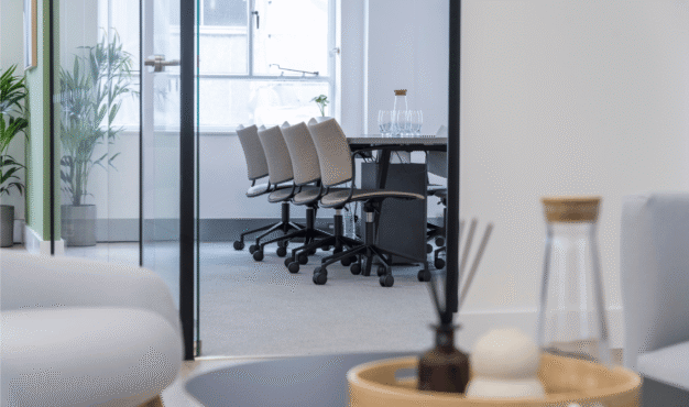 Meeting room with water bottle and table in foreground